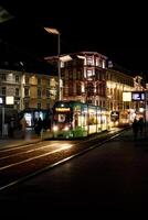 verticale foto fotografia di tram nel città luci a notte con giallo luci