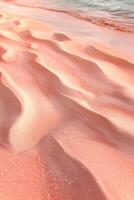 ai generato sabbia dune su un' spiaggia con rosa sabbia foto