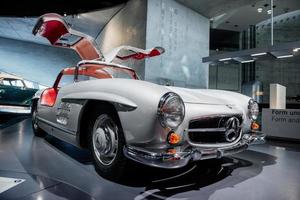 Stoccarda, Germania - 16 ottobre 2018 museo mercedes. altra auto verde sullo sfondo. veicolo retrò bianco con salone rosso e porte aperte in piedi al car show foto