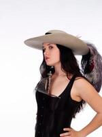 caucasico donna nel piuma cappello e nero corsetto foto