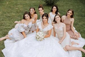 nozze fotografia. un' brunetta sposa nel un' bianca vestito con un' mazzo e sua brunetta amiche foto