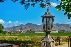 un antico europeo nordico stile lampada decorazione con un' fondale di montagna e riso campo visualizzazioni quello Guarda sfocato e su di messa a fuoco foto