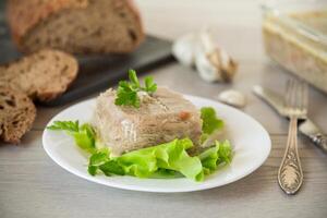 bollito pollo carne gelatina nel carne gelatina brodo nel un' piatto foto