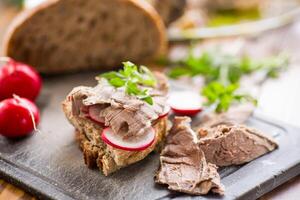 Sandwich con al forno carne, ravanello e erbe aromatiche foto
