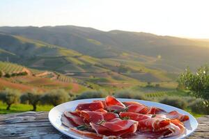 ai generato piatto di jamon iberico con il rotolamento colline di andalusia nel morbido tramonto leggero - autentico spagnolo delicatezza foto