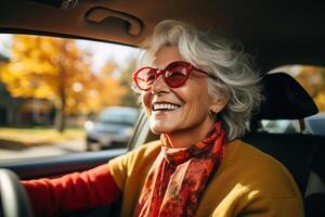 ai generato positivo anziano donna nel occhiali da sole guida un' macchina, dentro. sorridente allegro anziano signora autista foto