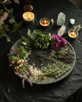 ai generato mistico atmosfera, piatto con erbe aromatiche candele e cristalli foto