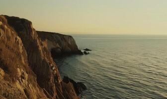 ai generato bellissimo paesaggio marino con scogliere e mare nel il sera. foto