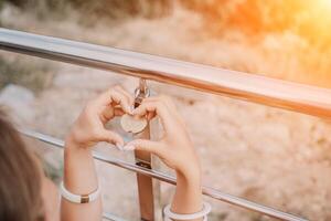 mani, serratura, cuore, amore, san valentino giorno. avvicinamento di un' donna di mani Tenere cuore sagomato lucchetto con un' cuore. il concetto di San Valentino giorno, nozze, simbolo di amore e fedeltà. foto