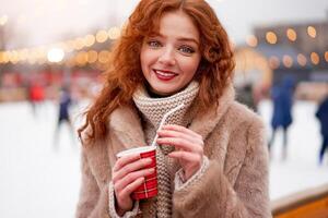 giovane bellissimo testa Rossa ragazza lentiggini ghiaccio pista su sfondo. bella donna Riccio capelli ritratto a piedi su nuovo anno giusto foto