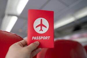 mano Tenere passaporto nel il aereo cabina. foto