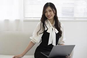 un' Lavorando giapponese donna di a distanza opera nel il casa ufficio avvicinamento foto