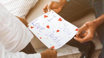 poco ragazza dando fatto a mano cartolina per padre foto