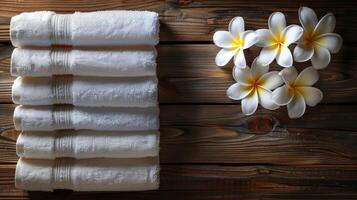ai generato pila di bianca asciugamani su di legno tavolo foto