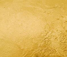scintillante oro strutturato metallico sfondo. foto