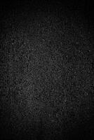 astratto nero granuloso struttura copertura su asfalto sfondo. foto