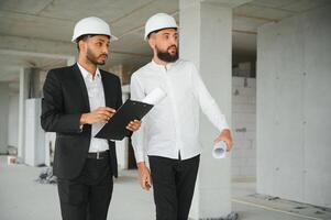 costruzione concetto di multirazziale ingegnere e architetto Lavorando a costruzione luogo con blu Stampa foto