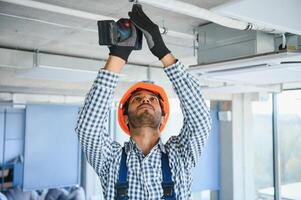 HVAC indiano lavoratore installare canalizzato tubo sistema per ventilazione e aria condizionata. copia spazio foto