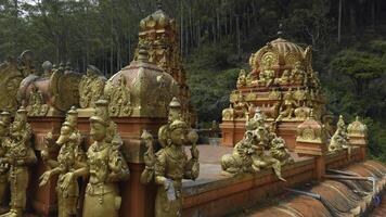 indù tempio con d'oro statue. azione. rosso tempio con d'oro buddista statue. tempio di indù origine nel sri lanka foto