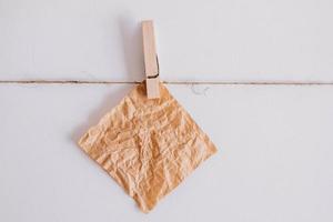 adesivi marroni su stendibiancheria con molletta in legno isolato su sfondo bianco. posto per il tuo testo foto