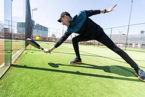 uomo giocando pagaia tennis. salto e tiro il sfera. foto