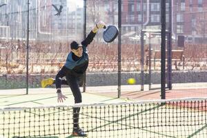 uomo giocando pagaia tennis. salto e tiro il sfera. foto