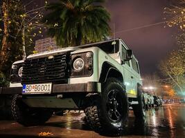 budva, montenegro - 25 dicembre 2022. bianca suv terra rover è parcheggiata sotto un' albero foto