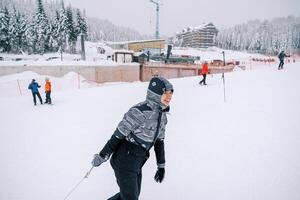 sorridente giovane donna traino un' slitta con un' corda su il montagna. lato Visualizza foto