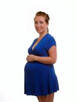 giovane incinta donna nel solido blu vestito foto