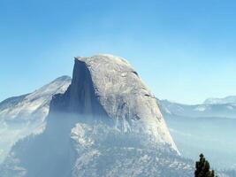 mezza cupola Yosemite nazionale parco con Fumo a partire dal fuoco foschia foto