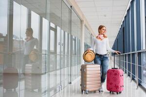 casualmente vestito giovane elegante femmina viaggiatore controllo un' Partenze tavola a il aeroporto terminale sala nel davanti di dai un'occhiata nel contatori. volo programma Schermo blured nel il sfondo. messa a fuoco su donna. foto