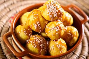 luqaimat o loto gaimat dolce palle con sesamo semi servito nel piatto isolato su tavolo superiore Visualizza di Arabo dolce foto