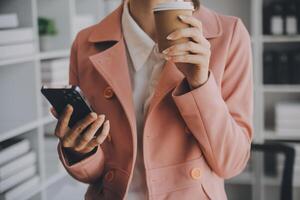 il ritratto di una giovane donna asiatica libera professionista sta lavorando sul tablet del computer in un ufficio moderno. fare un rapporto di analisi contabile dati di investimento immobiliare, concetto di sistemi finanziari e fiscali. foto