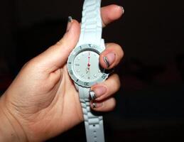 un' mano Tenere un' grigio orologio foto