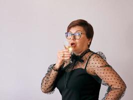 elegante donna anziana matura con un bicchiere di vino. divertimento, festa, stile, stile di vita, lavoro, alcol, concetto di celebrazione