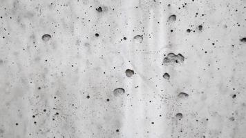trama del muro di cemento grigio. la trama della vecchia superficie bianca per lo sfondo foto