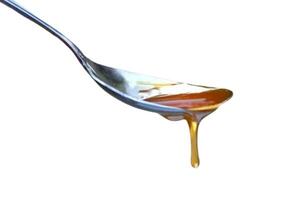 cucchiaio di miele isolato su bianca sfondo foto
