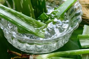 gel di aloe vera in una ciotola con sul tavolo di legno foto