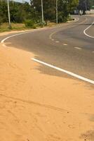 deserto sabbia passaggi su un asfalto strada. foto