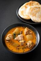 zuppa di pollo al curry con roti foto