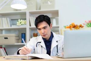 foto di giovane asiatico maschio medico Lavorando a ufficio