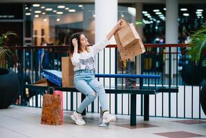 shopping volta, adolescenziale ragazza con shopping borse a shopping centro commerciale. shopping concetto foto