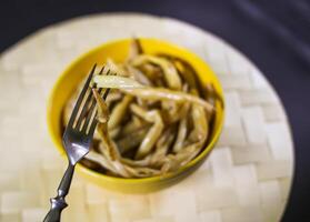 fritte lungo francese fagioli nel giallo ceramica tazza. foto