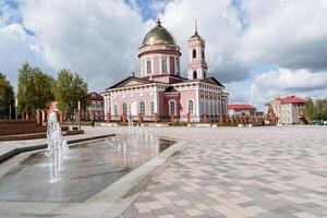 ortodosso Chiesa nel un' piccolo ural città, un' rosa Chiesa, un' d'oro cupola con un' attraverso, un' campana Torre, un' cristiano santuario. foto