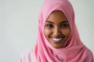 ai generato ritratto di giovane musulmano donna nel rosa hijab sorridente. foto