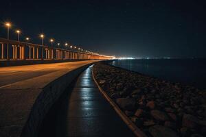un' lungo ponte con luci su esso a notte foto