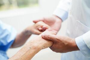 asiatico medico toccante paziente per sostegno, consolazione incoraggiare e Aiuto supporto Salute cura medico. foto