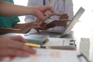 medico squadra incontro in giro tavolo nel moderno ospedale foto