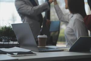 gli analisti finanziari analizzano i rapporti finanziari aziendali su un progetto di investimento di pianificazione di un tablet digitale durante una discussione in una riunione aziendale che mostra i risultati del loro lavoro di squadra di successo. foto