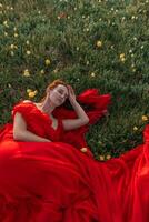 un' donna nel un' rosso vestito è posa nel un' campo di giallo fiori. il scena è sereno e tranquillo, calmo, con il donna apparendo per essere nel un' stato di rilassamento. foto